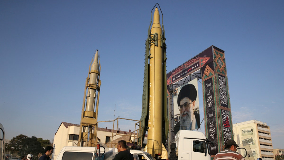 A Ghadr-H missile, center, a Sejjil missile and a portrait of the Iranian Supreme Leader Ayatollah Ali Khamenei are on display for the annual Defense Week, marking the 37th anniversary of the 1980s Iran-Iraq war, at Baharestan Sq. in Tehran, Iran, Sunday, Sept. 24, 2017. Iran