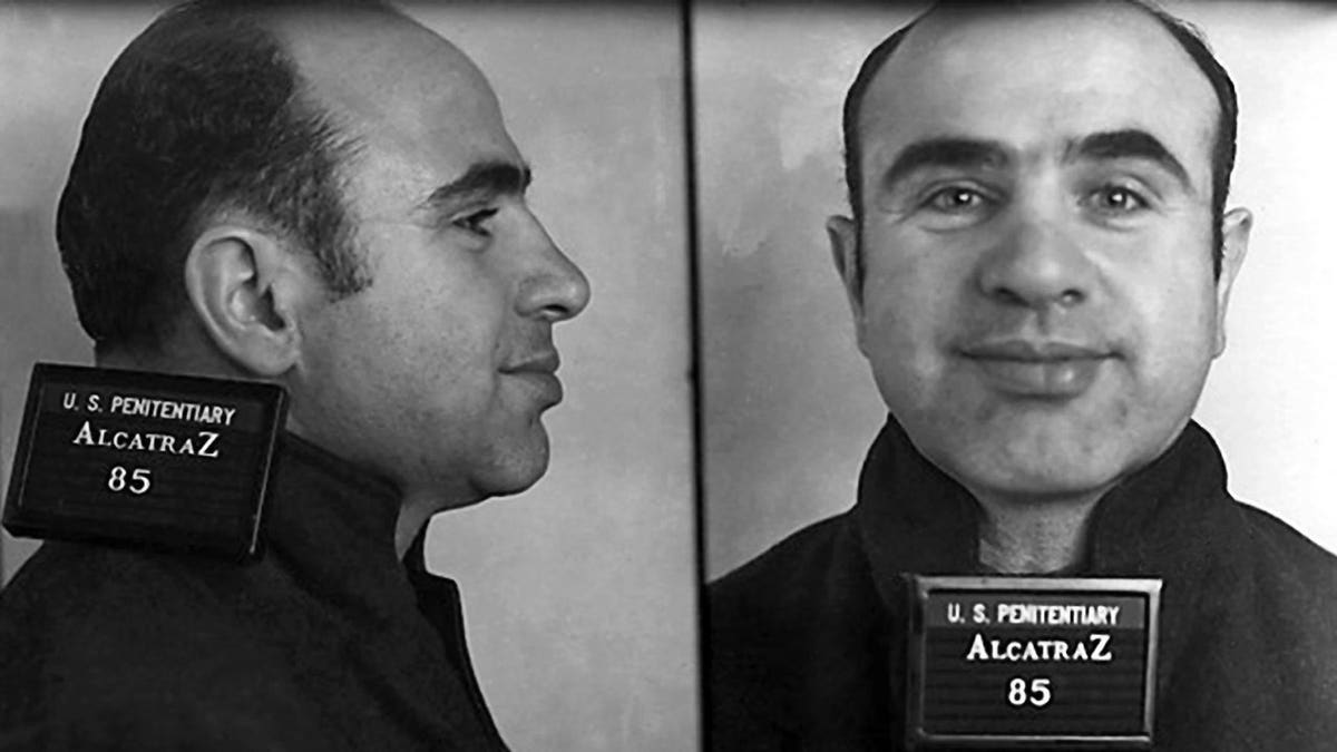 Alphonse Capone posing for a mugshot at Alcatraz Federal Penitentiary.